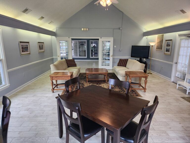 Common room with sofas, coffee table and a dining table